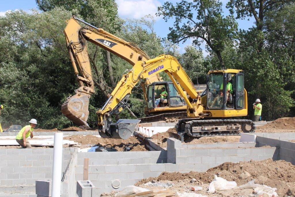 WoodStone Earth crew installing underground utilities at a residential development